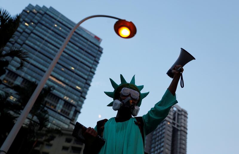 A protestor dressed as the Statue of Liberty, attends a protest in Central, Hong Kong, China September 8, 2019. REUTERS/Kai Pfaffenbach