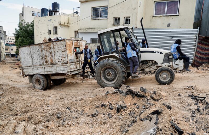 Members of UNRWA at work following an Israeli raid in Jenin camp in the Israeli-occupied West Bank. Reuters