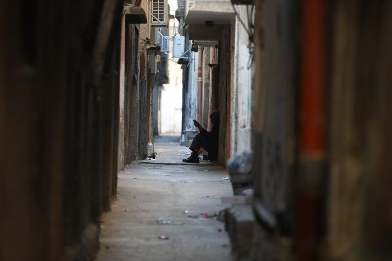 epa06426184 A Palestinain refugee sits outside his home in a narrow street of the Balata refugee camp near the West Bank city of Nablus, 09 January 2018. Media report that the US President Donald J. Trump had vowed to freeze about 125 million US dollar of aid for the United Nations Relief and Works Agency (UNRWA) for Palestine Refugees. The US ambassador to the United Nations (UN), Nikki Haley, was quoted as saying that Trump did not want to add or stop funding until the Palestinians were agreeing to return to the negotiation table. Following the 1948 Arab-Israeli conflict, UNRWA was established by the United Nations General Assembly Resolution 302 (IV) in 1949 to carry out direct relief and works programs for Palestine refugees from May 1950 on. Until today, some five million Palestine refugees are eligible for their services, UNRWA says on their website.  EPA/ALAA BADARNEH