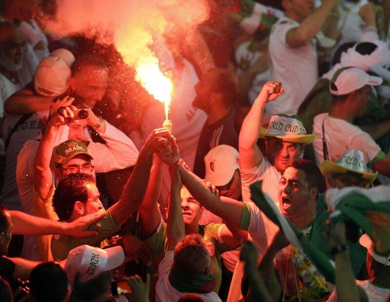 Algeria fans light a flare after Islam Slimani's goal against Russia on Thursday at the 2014 World Cup. Michael Sohn / AP