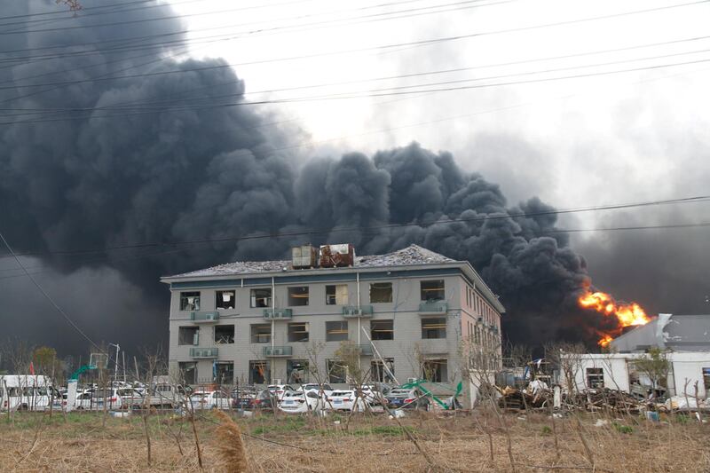 Smoke billows from fire behind a damaged building following the explosion at the pesticide plant owned by Tianjiayi Chemical. Reuters