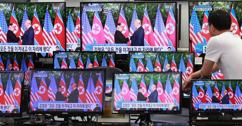 A man watches television screens showing the summit between US President Donald Trump and North Korean leader Kim Jong Un, at an electronics shopping centre in Seoul. Yonhap / AFP
