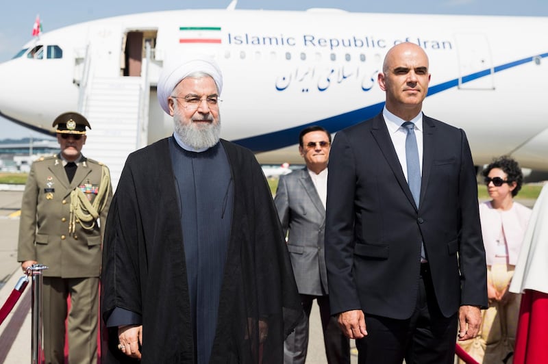 epa06858199 Swiss Federal President Alain Berset (R) welcomes Iranian President Hassan Rouhani (L) during his visit to Switzerland at the Zurich airport in Kloten, Switzerland, 02 July 2018. Rouhani arrived for a two-day visit.  EPA/PETER KLAUNZER
