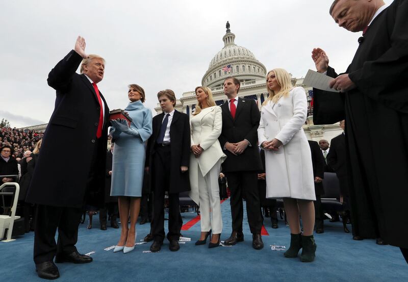 FILE - In this Jan. 27, 2017, file photo President Donald Trump takes the oath of office from Chief Justice John Roberts, as his wife Melania holds the Bible, and with his children Barron, Ivanka, Eric and Tiffany on Capitol Hill in Washington. (Jim Bourg/Pool Photo via AP, File)