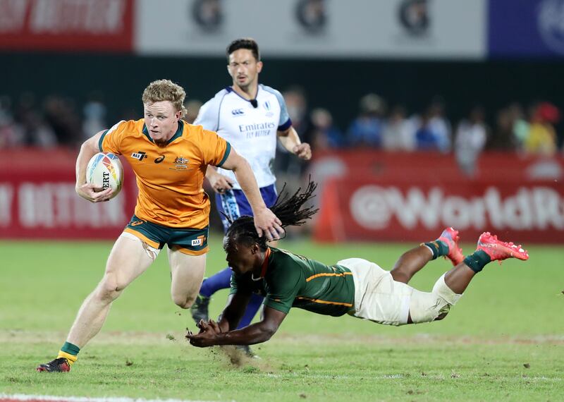 Australia's Henry Hutchison tries to skip a tackle during the Dubai Sevens final.
