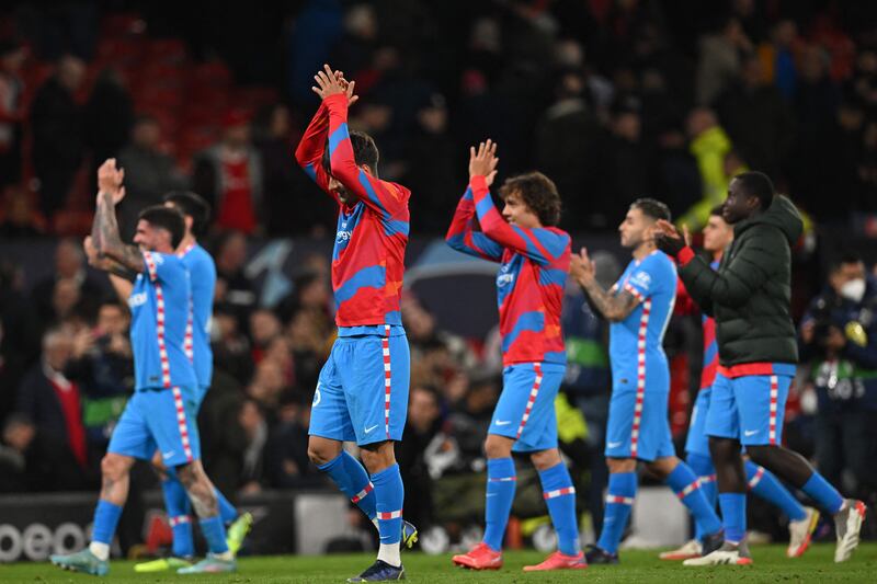 Atletico Madrid's players celebrate on the pitch. AFP