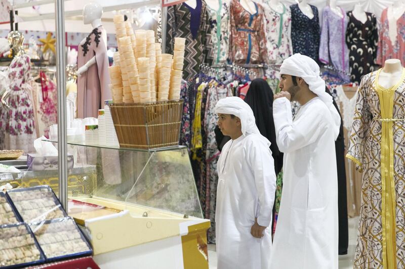 RAS AL KHAIMAH, UNITED ARAB EMIRATES - AUGUST 13, 2018. 

A boy stops for icecream at Ras Al Khaima's Eid Al Adha fair, in RAK's Exhibition center.

(Photo by Reem Mohammed/The National)

Reporter: RUBA HAZA
Section:  NA