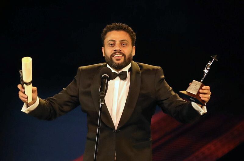 Egyptian director Ahmed Fawzy Salah receives an award for his film 'Poisonous Roses' during the closing ceremony of the 40th edition of the Cairo International Film Festival at the Opera House. Photo / Reuters