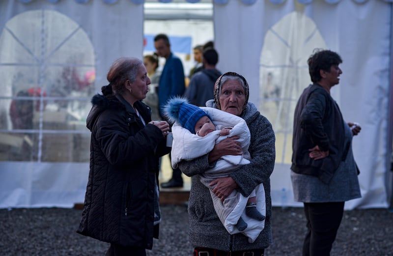 An elderly woman holding an infant waits as ethnic Armenians from Nagorno-Karabakh arrive to a registration center of the Armenian Ministry of Foreign Affairs, near the border town of Kornidzor, Armenia, 25 September 2023.  Azerbaijan on 19 September 2023 launched a brief military offensive on the contested region of Nagorno-Karabakh, a breakaway enclave that is home to some 120,000 ethnic Armenians.  Following a ceasefire agreed on 20 September 2023, Azerbaijan opened all checkpoints with Armenia for the unimpeded exit of civilians from the disputed territory.  The Armenian government announced the evacuation of more than 6,500 local residents from Nagorno-Karabakh, and a humanitarian center has been set up in the village of Kornidzor near the so-called Lachin corridor, the main route between Armenia and the breakaway region.  Russian peacekeepers escorted convoys with civilians leaving Nagorno-Karabakh for Armenia, the Russian defense ministry said.   EPA / NAREK ALEKSANYAN