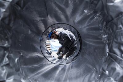 An employee uses tape to seal a packaged coil of rolled steel at the Jindal Stainless Ltd. factory in Hisar, Haryana, India, on Wednesday, May 16, 2018. India's biggest steelmakers are set to expand production to a record after reporting solid quarterly earnings amid strong steel prices. Photographer: Udit Kulshrestha/Bloomberg