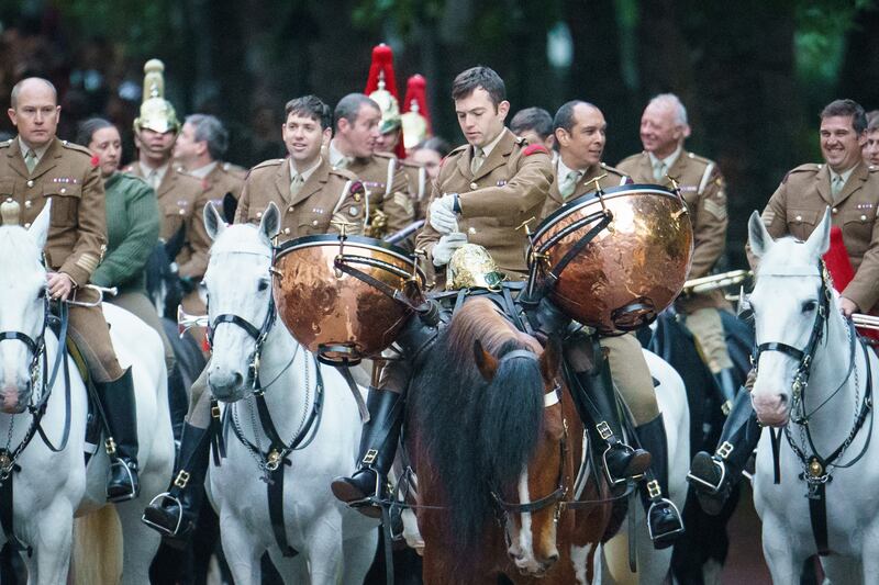 A member of the Household Cavalry checks his watch as service personnel from the Royal Navy, British Army and Royal Air Force conduct the final rehearsal. PA