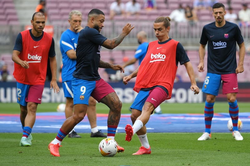 Antoine Griezmann and Memphis Depay warm up before the start of the match between Barcelona and Getafe. AFP