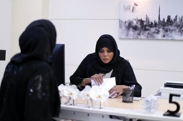 A woman nominates herself as a potential candidate for the Federal National Council elections, at the registration centre in Dubai. Reem Mohammed / The National
