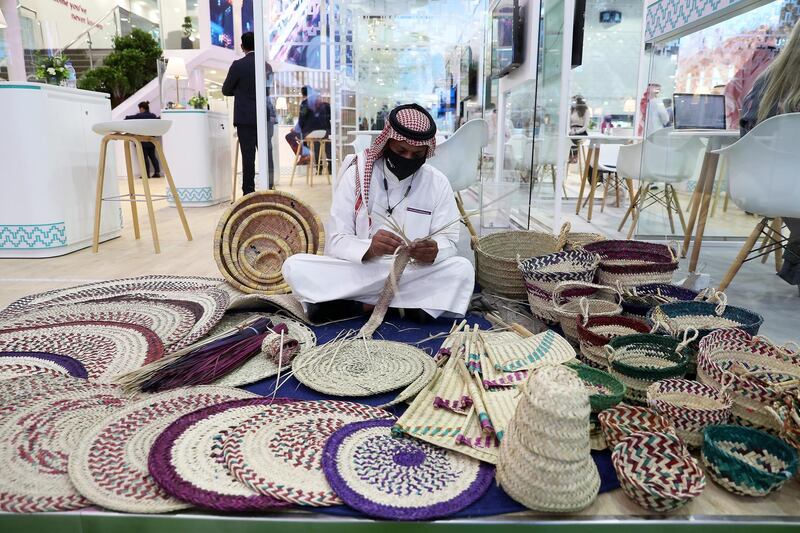 Artist making items from palm leaves at the Saudi Arabia stand during the Arabian Travel Market held at Dubai World Trade Centre in Dubai on May 16,2021. Pawan Singh / The National. Story by Deena