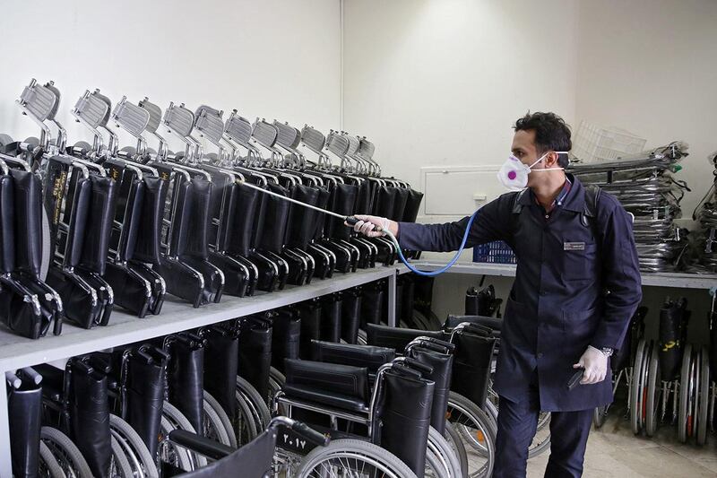 Wheelchairs are sprayed with disinfectant at Imam Reza's holy shrine. West Asia News Agency via Reuters