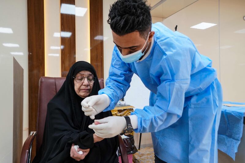 Intissar Mohammed, whose brother is missing, provides a blood  sample for authorities who suspect her brother's remains could be at the Najaf site.