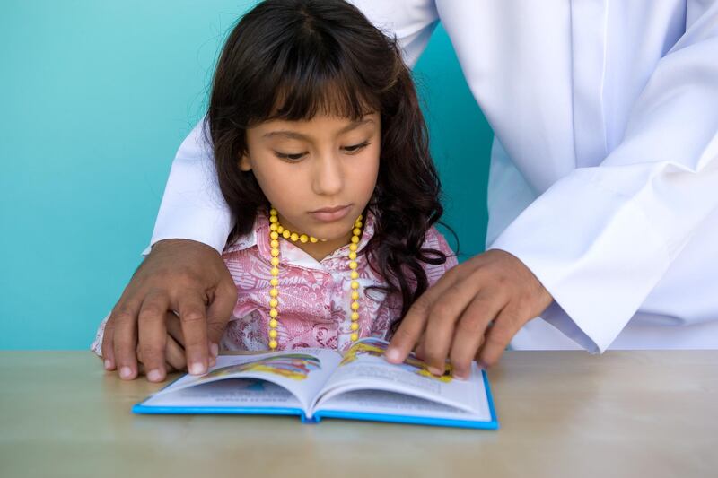 A young girl reading a book.