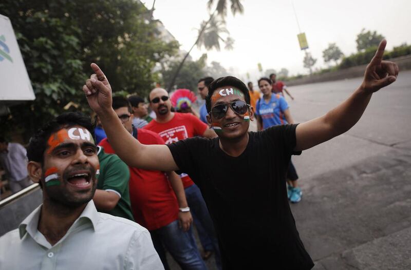 Fans in the queue in Mumbai with their faces painted on Thursday. Danish Siddiqui / Reuters