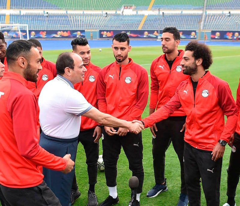 Egyptian President Abdel Fattah El Sisi greets Egypt's UEFA Champions League winning Liverpool forward Mohamed Salah during the national team's training camp at the 30 June Stadium in Cairo on June 15, 2019. AFP