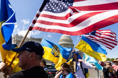 Supporters of Ukraine wave US and Ukrainian flags outside the US Capitol on April 21 after the House of Representatives approved foreign aid packages to Ukraine, Israel and Taiwan. EPA