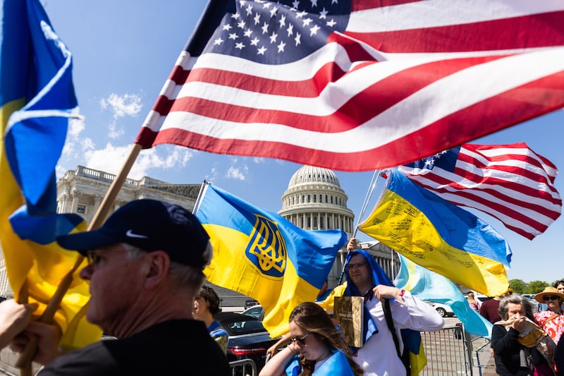 Supporters of Ukraine wave US and Ukrainian flags outside the US Capitol after the House of Representatives approved foreign aid packages to Ukraine, Israel and Taiwan. EPA
