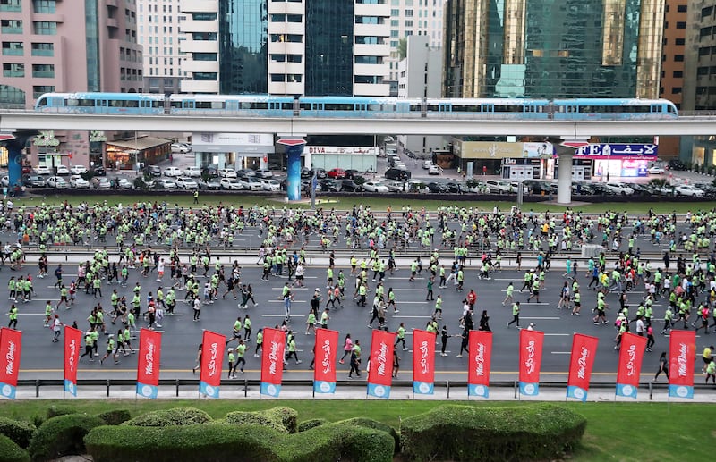 Participants of Dubai Run 2022 throng Sheikh Zayed Road. All photos: Pawan Singh / The National unless otherwise specified