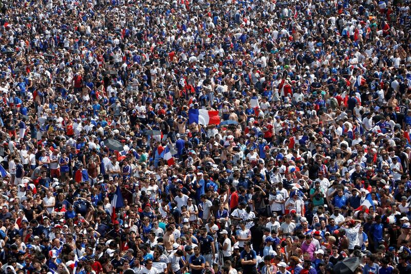 Supporters wave French flags as they gather on the fan zone on the Champ de Mars in Paris. AFP