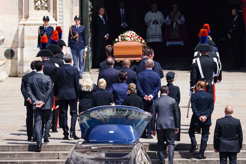 The casket is carried up the steps of Duomo Cathedral. AP