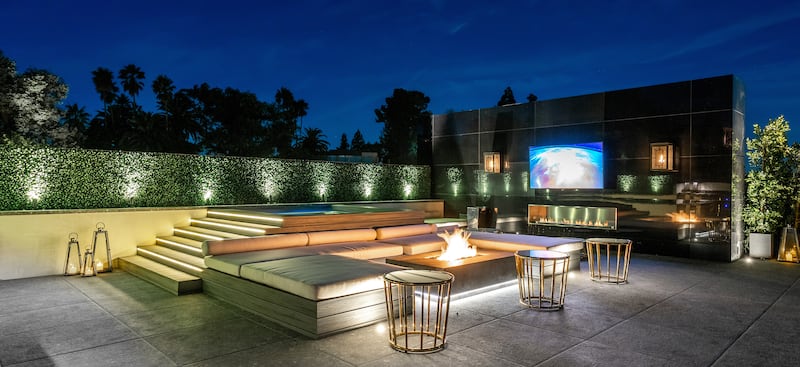 An outdoor seating area with screens and a firepit.