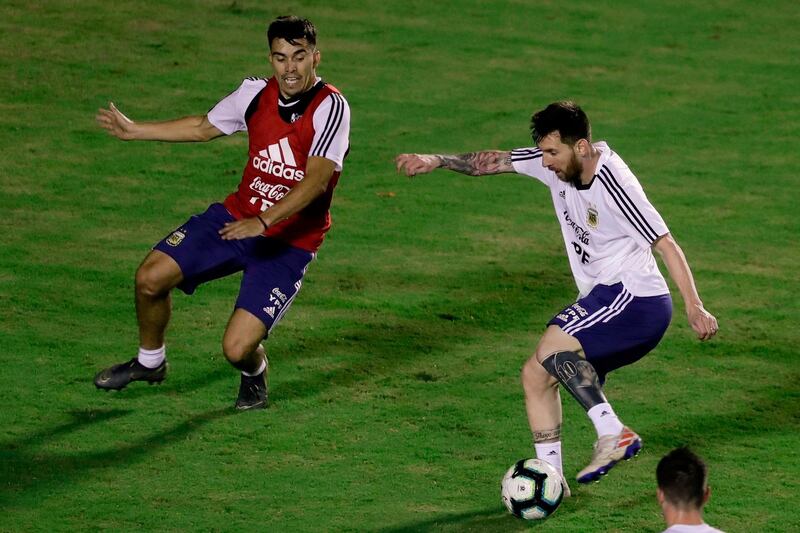 Messi looks to get past Marcos Acuna during training. AFP