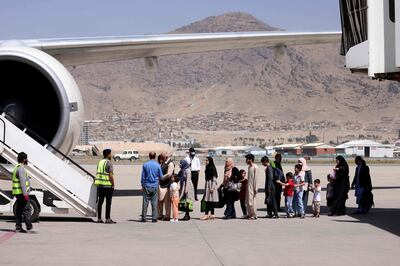 Passengers queue at Kabul Airport to leave Afghanistan. Karim Sahib / AFP