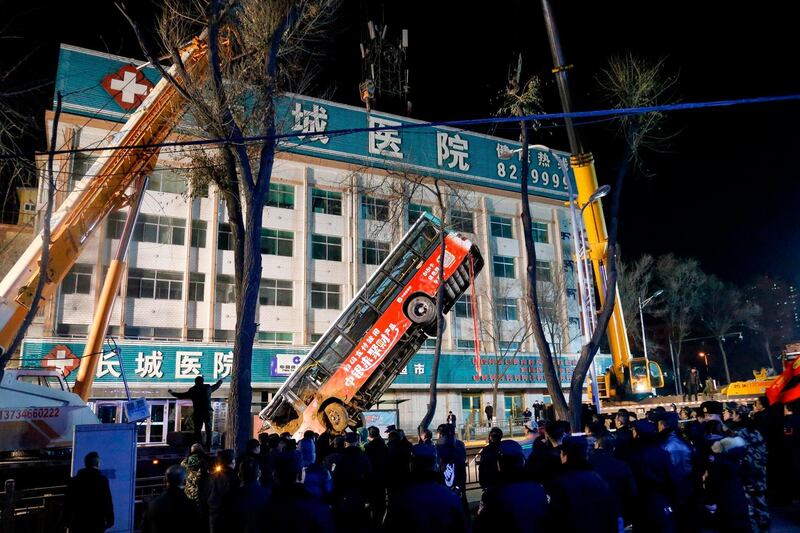 A crane lifts out the bus. AFP