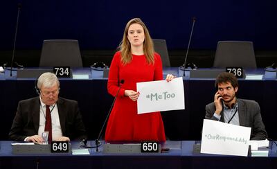 European Parliament member Terry Reintke (C) holds a placard with the hashtag "MeToo" during a debate to discuss preventive measures against sexual harassment and abuse in the EU at the European Parliament in Strasbourg, France, October 25, 2017.  REUTERS/Christian Hartmann