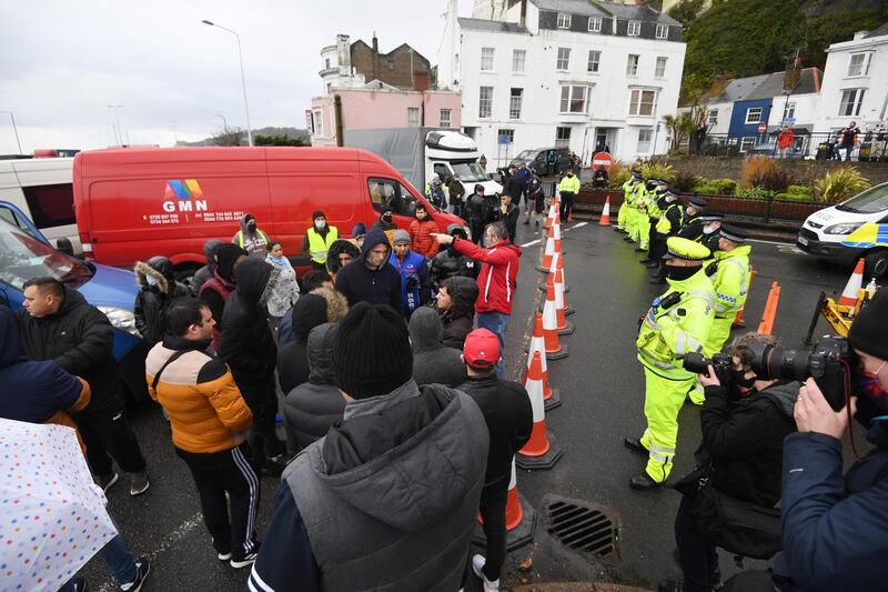 epa08900880 Police stand at the entrance of the Port of Dover after freight lorries cannot cross by sea or through the Eurotunnel and the Port of Dover has closed to outbound traffic in Dover, Britain, 23 December 2020. France closed its border with the UK for 48 hours over concerns about the new coronavirus variant. Lorry drivers must now obtain negative coronavirus tests before they will be allowed to cross by sea and the Port of Dover remains closed to outbound traffic on the morning of 23 December 2020.  EPA/FACUNDO ARRIZABALAGA