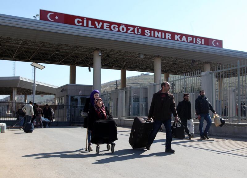 HATAY, TURKEY - FEBRUARY 11: Syrian people's escape from Syrian civil war is going on. More than 10,000 Syrians have came to Turkey's Cilvegozu Border Gate at Reyhanli district of Hatay, Turkey. People come to the border gate by walking, with cars or small lorries carrying a piece of stuff. (Photo by Ahmet Bolat/Anadolu Agency/Getty Images)