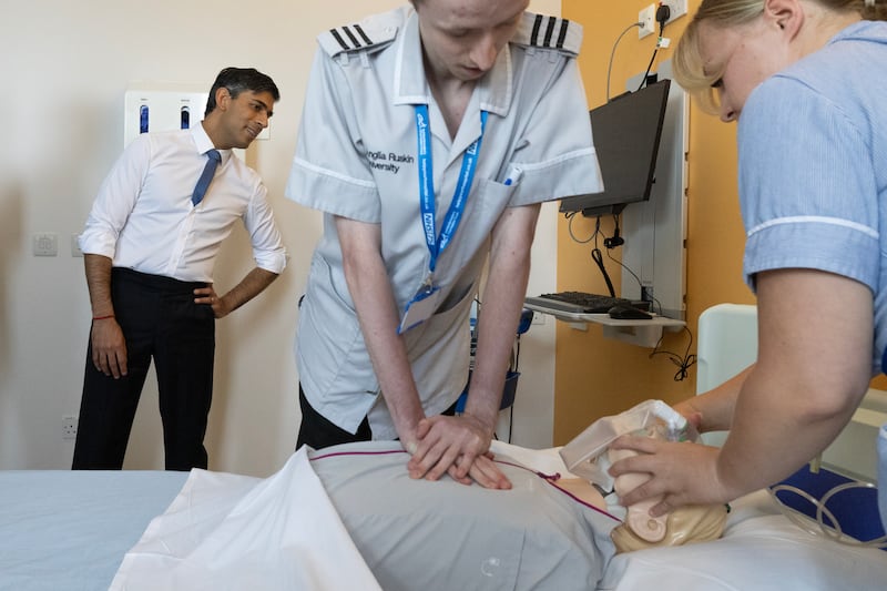Prime Minister Rishi Sunak is given a demonstration of CPR while visiting the NHS's Addenbrooke's Hospital in 2023. Getty Images