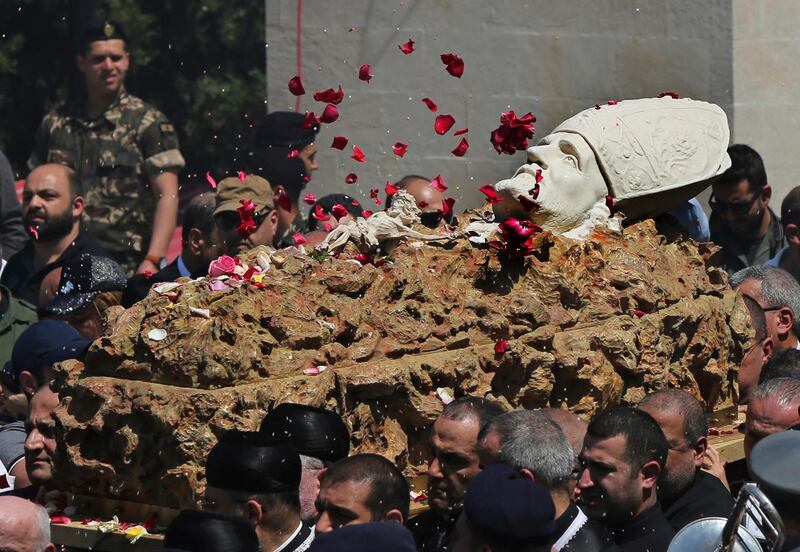 Mourners throw flowers on the coffin of former Maronite Patriarch Cardinal Mar Nasrallah Boutros Sfeir, as it arrived at the seat of the Maronite Church, in the village of Bkirki, north of Beirut, Lebanon. AP Photo