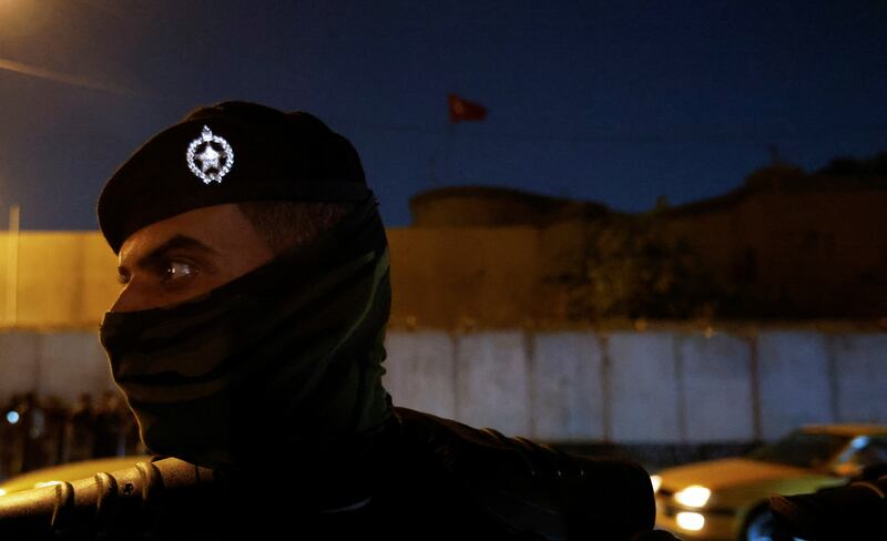 A riot police officer stands in front of a building belonging to the Turkish Embassy in Baghdad during a demonstration. Reuters