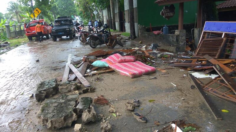 Debris from damaged buildings is seen on a street on Carita beach. AFP