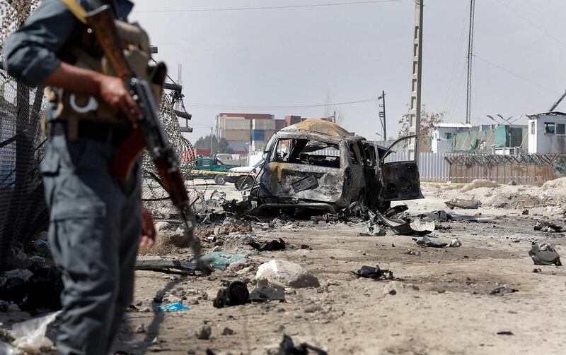 epa06609514 Afghan security officials inspect the scene of a suicide car bomb attack in Kabul, Afghanistan, 17 March 2018. A suicide attacker blew up a bomb in a car at Kabul, killing at least two civilians. Several others were reportedly injured in the blast claimed by the Taliban that the Afghan interior ministry said had targeted the global security company G4S.  EPA/HEDAYATULLAH AMID