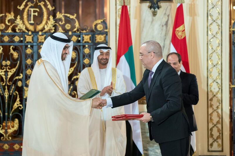 ALEXANDRIA, EGYPT - March 27, 2019: HH Sheikh Mohamed bin Zayed Al Nahyan, Crown Prince of Abu Dhabi and Deputy Supreme Commander of the UAE Armed Forces (back L) and HE Abdel Fattah El Sisi President of Egypt (back R), witness an MOU signing ceremony at Ras El Tin Palace. Seen signing on behalf of the UAE is HE Dr Sultan Ahmed Al Jaber, UAE Minister of State, Chairman of Masdar and CEO of ADNOC Group (front L) and for Egypt, HE Dr Assem Abdel Hamid el Gazzar, Minister of Housing, Utilities and Urban Communities of Egypt (front R).

( Rashed Al Mansoori / Ministry of Presidential Affairs )
---