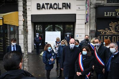 French Prime Minister Jean Castex, center, and Paris Mayor Anne Hidalgo, 3rd right, participate in a wreath laying ceremony, marking the 5th anniversary of the Nov. 13, 2015 attacks outside the Bataclan concert hall in Paris, Friday, Nov. 13, 2020. In silence and mourning, France is marking five years since 130 people were killed by Islamic State extremists who targeted the Bataclan concert hall, Paris cafes and the national stadium. (Christophe Archambault/Pool Photo via AP)