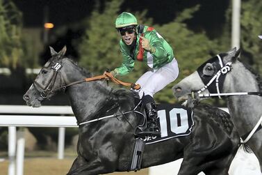 Jockey Julien Auge celebrates the big win for Al Shamoos in Abu Dhabi. Pawan Singh / The National