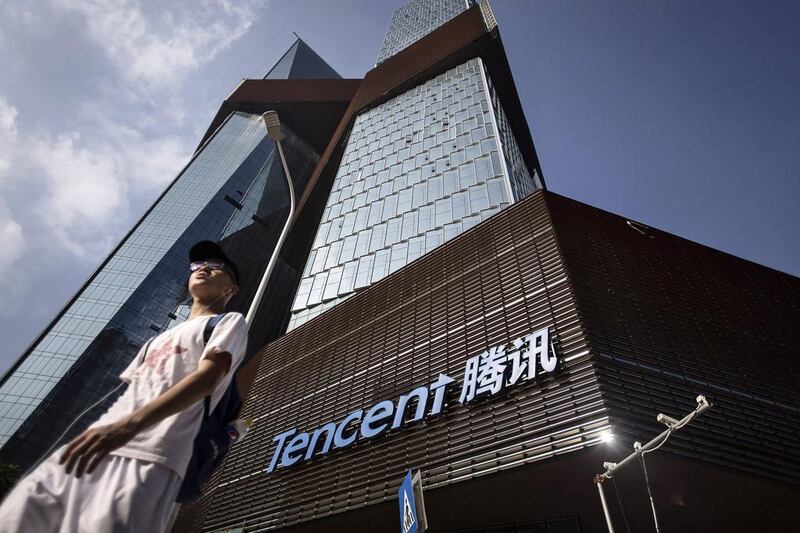Tencent’s new headquarters in Shenzhen, left; and a Made in China clothes tag. The bulk of electronic and consumer goods exported from China are either unbranded or produced for foreign companies such as Apple. Qilai Shen / Bloomberg; Brent Lewin / Bloomberg
