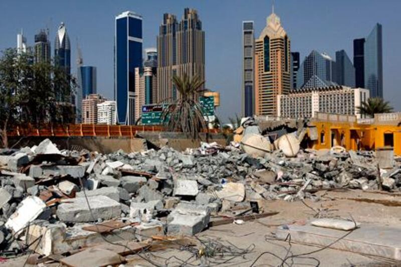 Dubai, United Arab Emirates- July 26, 2013:  Demolition of old villas and buildings near first interchange in Dubai's Satwa neigborhood. Residence are concerned about the possiblity of asbestos being present in the dust from the demolition. ( Satish Kumar / The National ) For News/ Story by  Vesela
