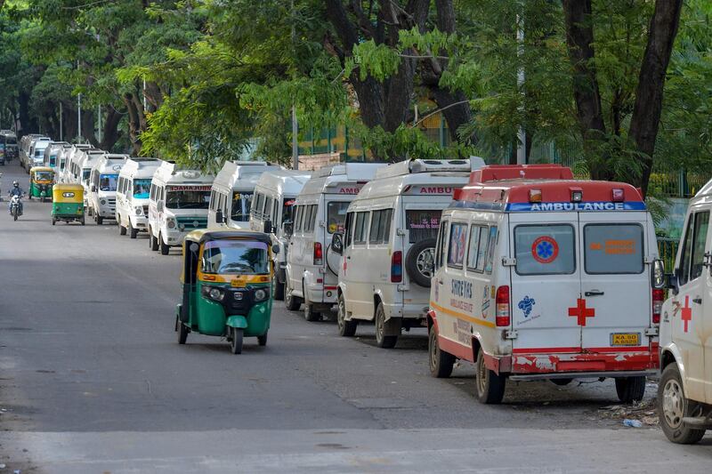 Lines of ambulances used during Covid-19 emergencies stand parked on the roadside in Bangalore. AFP