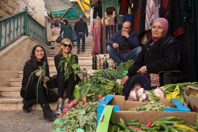 A photo of Lama Bazzari, centre, and Farrah Abuasad, left, during a trip to Palestine before publishing 'Craving Palestine'. Supplied