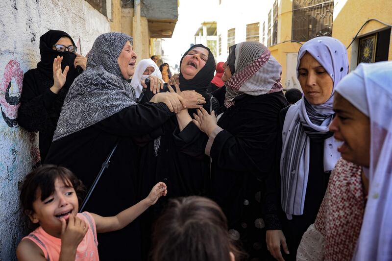 Women mourn during a funeral of a family killed in Israeli strikes on the Palestinian city of Rafah in the Gaza Strip. AFP