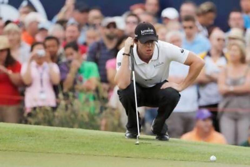 Rory McIlroy of Northern Ireland lines up his putt on the 18th green.