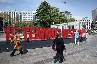 Local pass by 15 July Victory sign on Kizilay Guvenpark in Ankara.